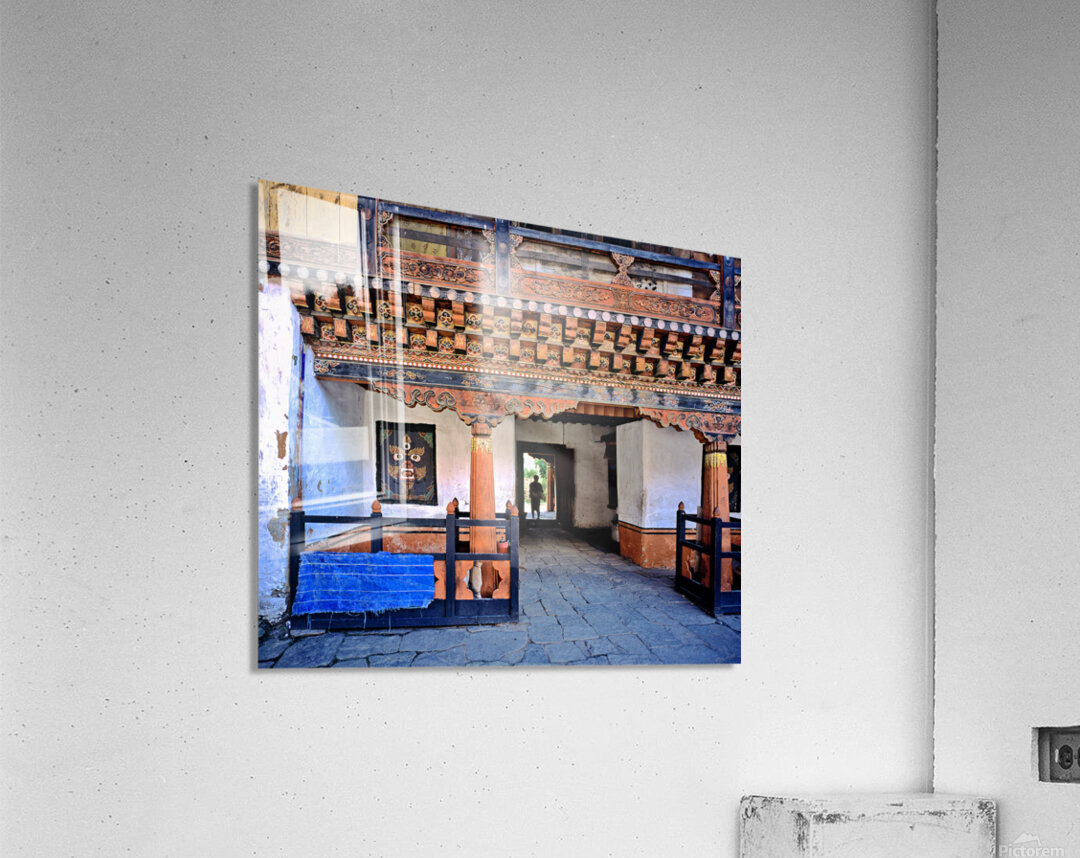 Intricate Bhutanese temple entrance with a person and fierce mas Acrylic Print