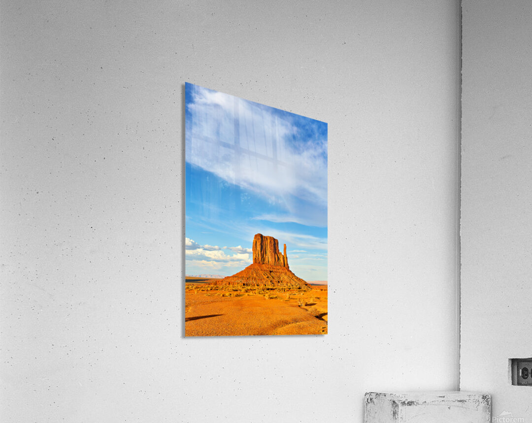 Monument Valley shows red rock formations under blue sky Acrylic Print