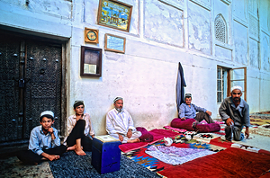 People sitting on carpeted floor in Khiva Uzbekistan