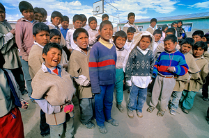 Diverse group of children posing outdoors with varied expression