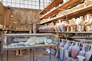 Pompeii site showing artifacts and a plaster cast of a victim