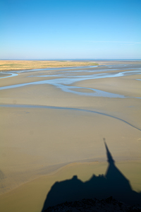 View of Mont Saint Michel abbey during low tide in Normandy Fran