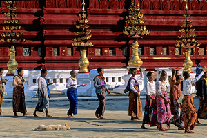Crowds walk by Shwezigon Paya in Bagan Myanmar during daylight by Marco Brivio