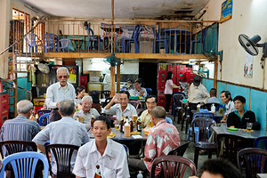 People gather in cafe in Ho Chi Minh City with drinks and food
