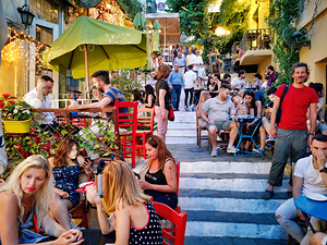 Dining and socializing in a crowded outdoor cafe in a city