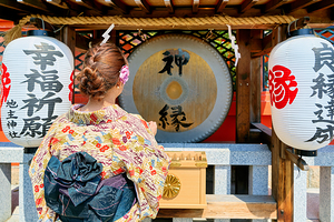Young woman prays at Kiyomizu Dera Temple in Kyoto Japan