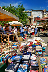 People walk around the bustling flea market at Monastiraki