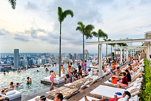 Visitors enjoy swimming in the infinity pool at Marina Bay Sands