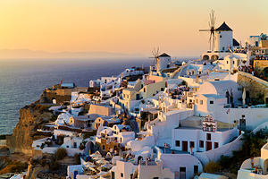 Santorini village at sunset with windmills overlooking the Aegea