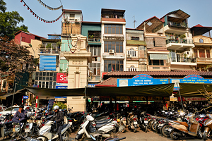 Market scene with motorcycles in Hanoi Vietnam during the day by Marco Brivio