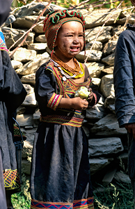 Children gather in a Kalash village wearing traditional clothes