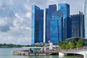 People are walking near a bridge in Singapores financial distri