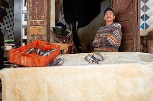 Fishmonger sits by his stall in Meknes Morocco market