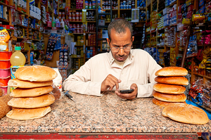 Sale of bread in the Medina of Fez Morocco with seller using p