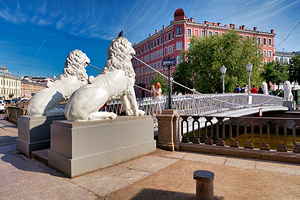Lions guard the bridge in Saint Petersburg on a sunny day