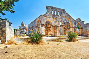 Visitors explore the ruins of Church of Saint Simeon Stylites in by Marco Brivio