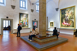 Large art gallery in Florence with visitors exploring the exhibi