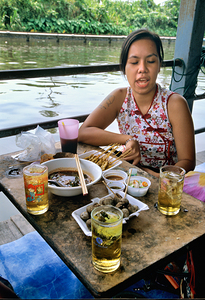 Eating at a floating market in Bangkok with local dishes