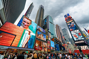 Crowd gathers in Times Square Manhattan during a cloudy day