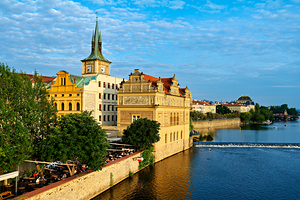 Pragues Vltava riverfront with historic architecture and lively
