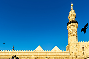 Mosque tower in Damascus against clear blue sky by Marco Brivio