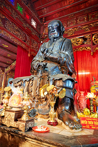 Statue of a monk in Ho Chi Minh City with traditional offerings