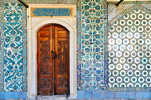 Exploring the tiled walls and wooden door at Topkapi Palace