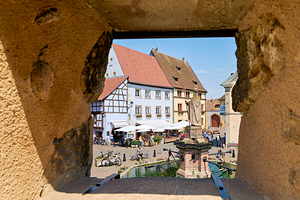 Visitors enjoy Saint Leon square in Eguisheim Alsace on wine rou