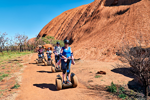 Tourists ride Segways near Uluru in Australia.