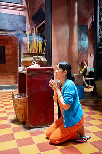 Woman prays at a temple in Ho Chi Minh City Vietnam