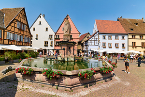 Visitors savor Saint Leon square in Eguisheim Alsace