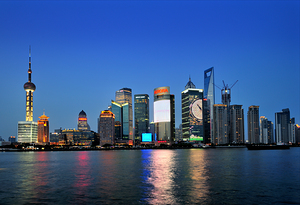 Shanghai skyline lights up at night over the river