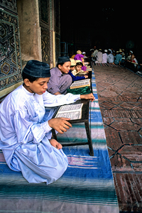 Students read in Quran school in Pakistan during the day by Marco Brivio