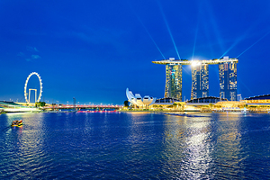 Sunset view of Marina Bay with city skyline and water reflection