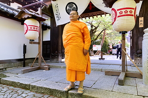 Monk stands at entrance of Chion in temple in Kyoto Japan