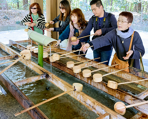 Hands being cleaned at Meiji Jingu shrine in Tokyo Japan