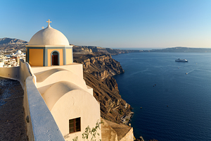 Santorini church overlooking caldera with cruise ship and blue s