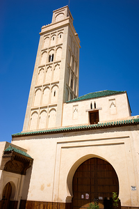 Visit Meknes mosque in Morocco with a tall tower and clear sky