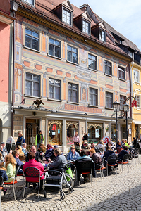 People relax at outdoor cafe on the Romantic Road in Bavaria by Marco Brivio