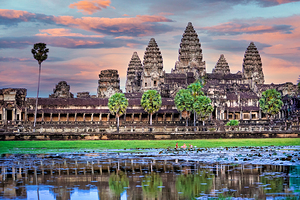 Angkor Wat temple at sunset reflected in a lotus pond.