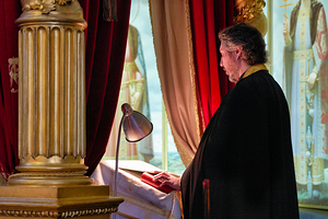 Man prays in Alexander Nevsky Lavra Monastery in St. Petersburg