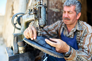 Shoemaker working in Aleppo souq in Syria