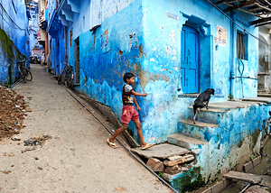 Colorful painted house in Bundi with a child walking by