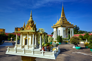 Ornate Cambodian temples under a clear blue sky. by Marco Brivio