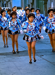 Women dance in blue costumes during a street parade in Argentina