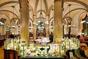 Historic cafe interior ornate architecture people enjoying pas