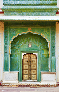 Green door of the City Palace in Jaipur invites visitors from in