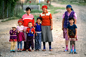 Children and women gather in a village in Uzbekistan