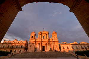 Noto Cathedral in Sicily Italy during sunset with archway view