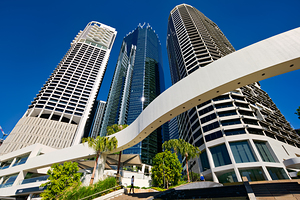 Woman walks on stairs in modern urban area with tall buildings